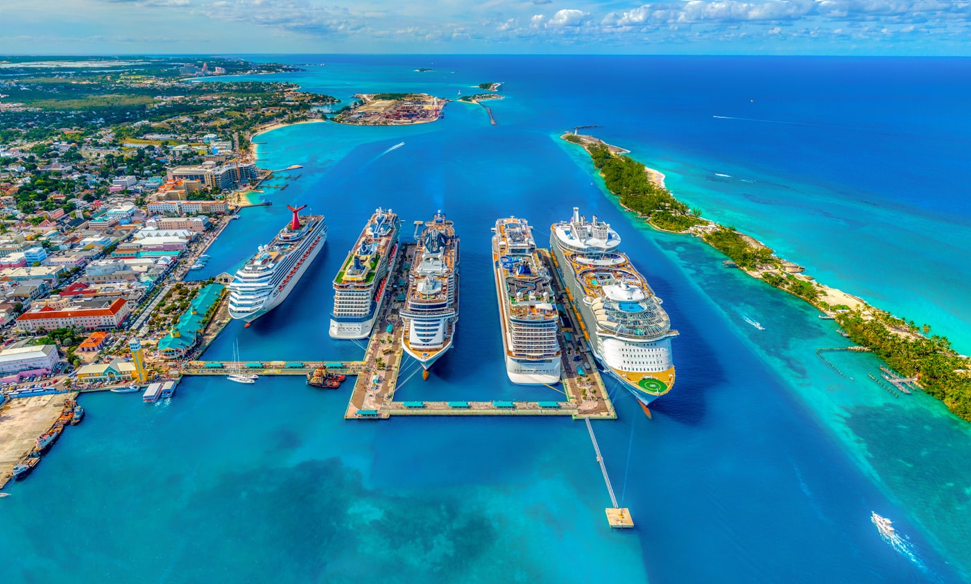 Cruise ships moored beside turquoise Caribbean water