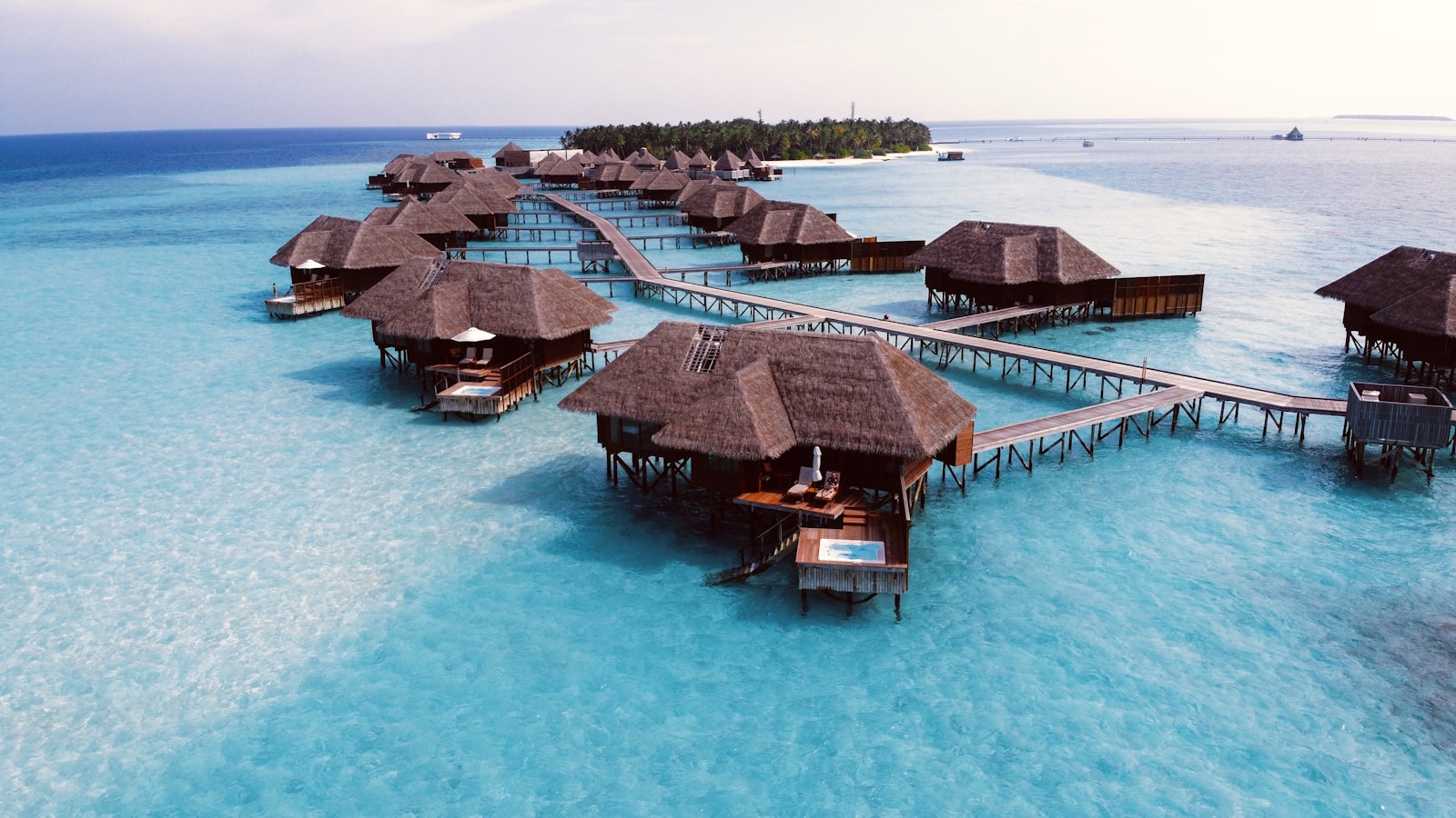 Overwater bungalows above a clear lagoon