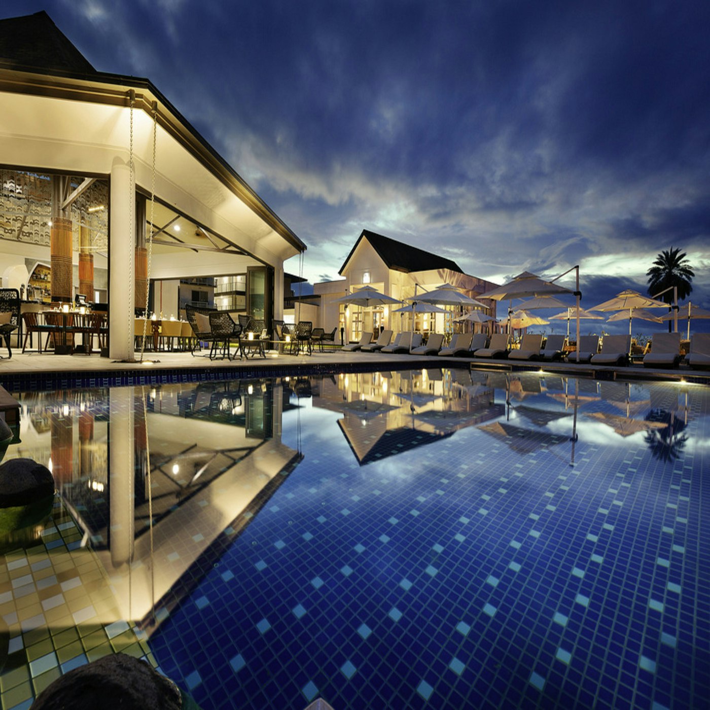 Resort pool lit at dusk